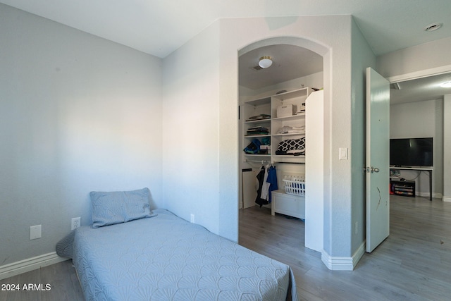 bedroom featuring a closet and hardwood / wood-style flooring