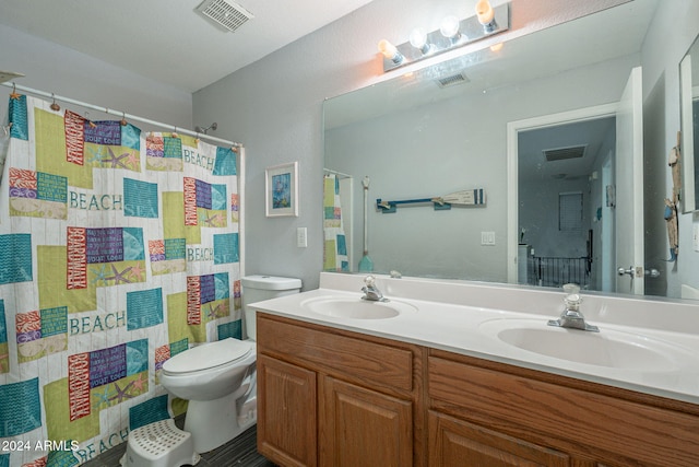 bathroom featuring a shower with shower curtain, vanity, and toilet