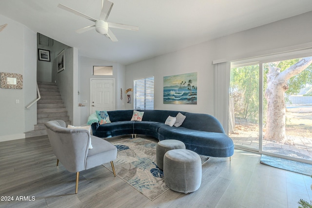 living room with ceiling fan, lofted ceiling, and hardwood / wood-style flooring