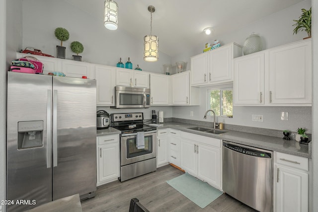 kitchen featuring white cabinets, sink, lofted ceiling, and stainless steel appliances