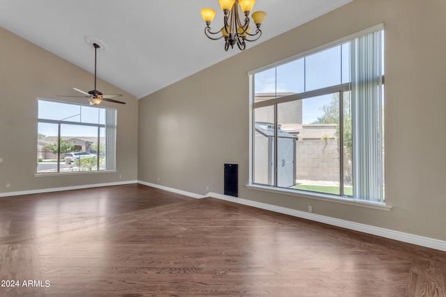 unfurnished living room featuring dark wood-type flooring, vaulted ceiling, and ceiling fan with notable chandelier