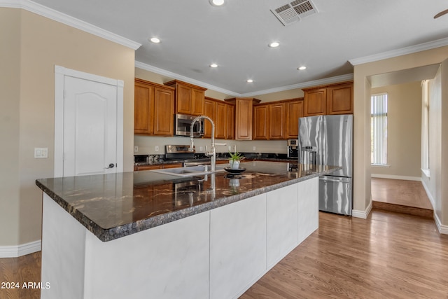 kitchen featuring a spacious island, stainless steel appliances, and light wood-type flooring