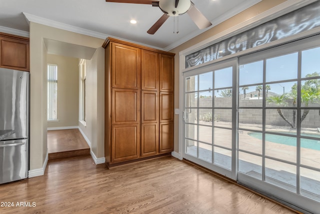 interior space with crown molding, light hardwood / wood-style floors, and ceiling fan