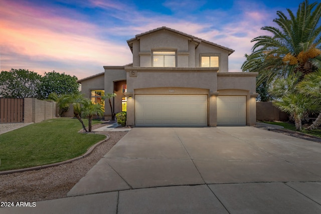 view of front of house with a garage and a lawn