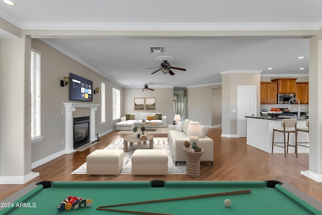 rec room featuring ceiling fan, billiards, ornamental molding, and dark hardwood / wood-style floors