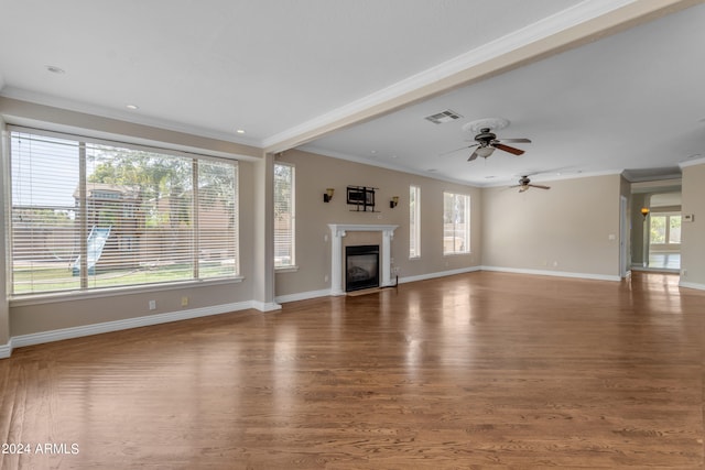 unfurnished living room with hardwood / wood-style flooring, crown molding, and ceiling fan