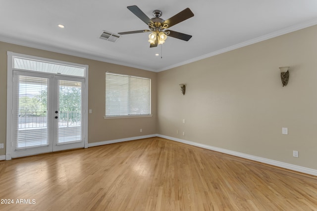 spare room featuring french doors, crown molding, ceiling fan, and light hardwood / wood-style flooring