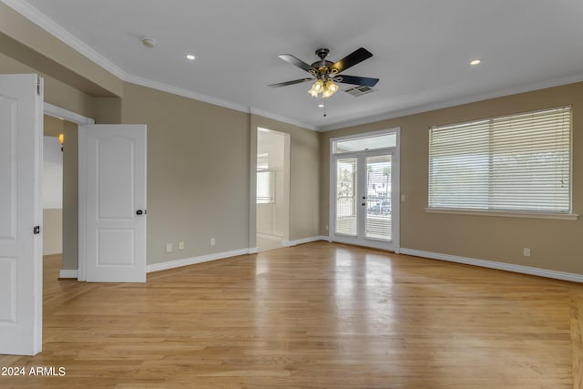 empty room featuring crown molding, ceiling fan, and light wood-type flooring