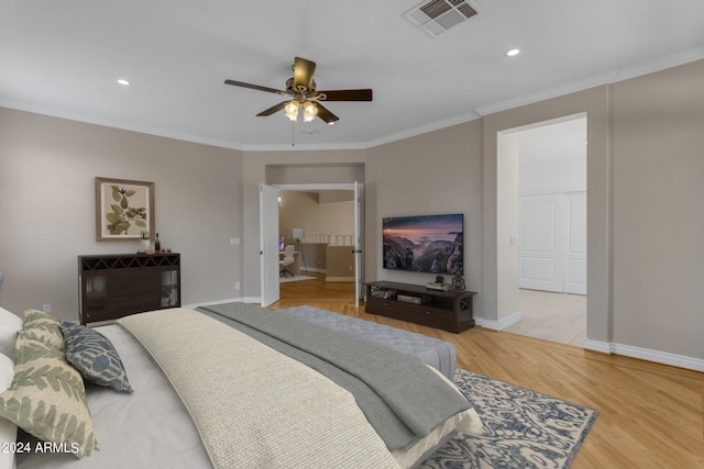 bedroom featuring ceiling fan, ornamental molding, and light hardwood / wood-style flooring