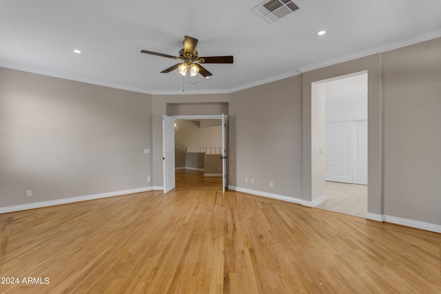 empty room featuring crown molding, ceiling fan, and light wood-type flooring