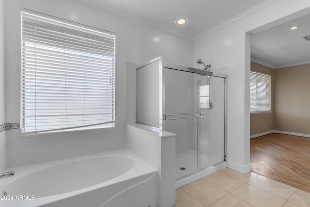 bathroom featuring independent shower and bath, crown molding, and tile patterned floors