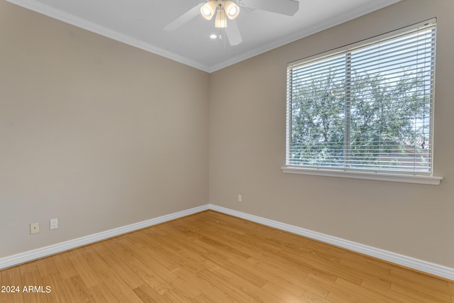 spare room featuring ornamental molding, ceiling fan, and light wood-type flooring