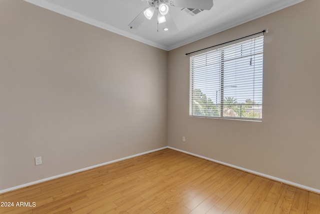 spare room featuring crown molding, ceiling fan, and light wood-type flooring