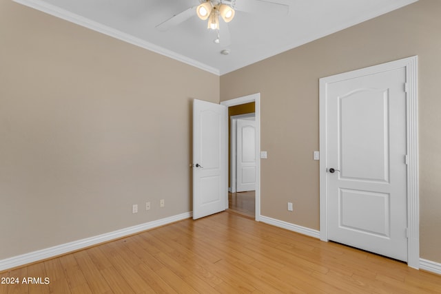 unfurnished bedroom featuring crown molding, ceiling fan, and light hardwood / wood-style floors