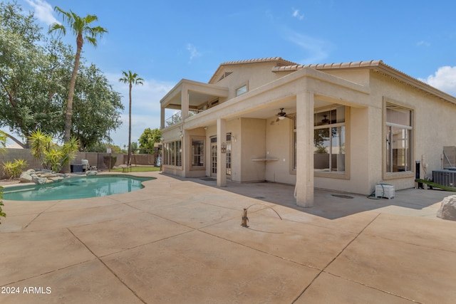 view of swimming pool with ceiling fan and a patio area