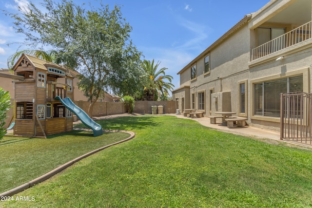 view of yard featuring a playground and a patio area