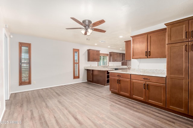 16638 N 46th Ln, Glendale, AZ 85306 - kitchen featuring brown cabinetry, light wood finished floors, and a ceiling fan