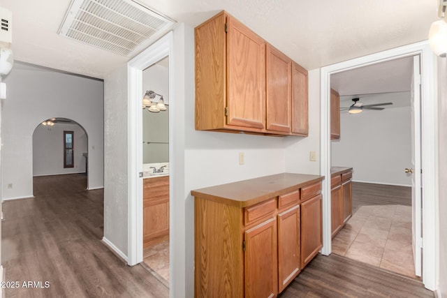 16638 N 46th Ln, Glendale, AZ 85306 - kitchen featuring visible vents, baseboards, arched walkways, ceiling fan, and wood finished floors