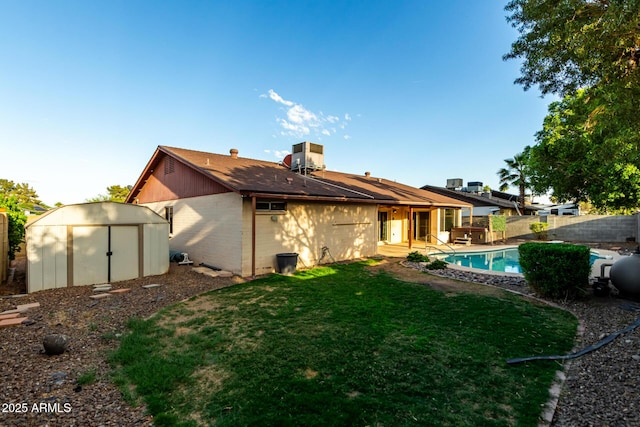 16638 N 46th Ln, Glendale, AZ 85306 - back of house with a storage shed, a yard, a fenced backyard, an outdoor structure, and cooling unit