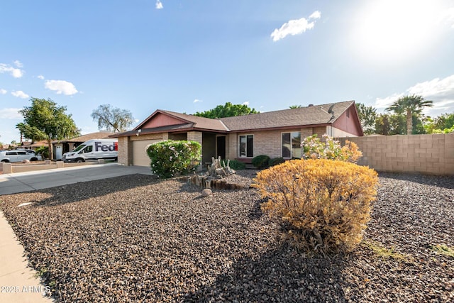 16638 N 46th Ln, Glendale, AZ 85306 - ranch-style house with brick siding, an attached garage, fence, and concrete driveway