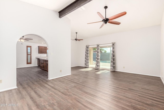 16638 N 46th Ln, Glendale, AZ 85306 - unfurnished living room with dark wood-type flooring, beamed ceiling, ceiling fan, and baseboards