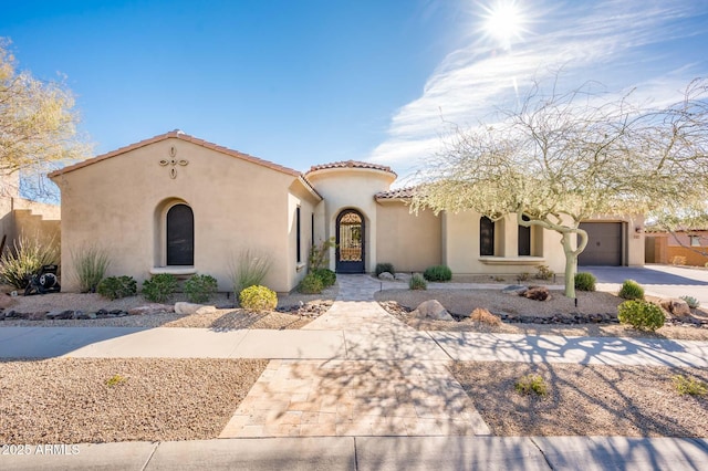 mediterranean / spanish-style home with a garage