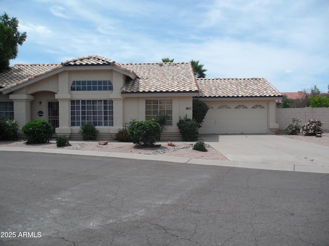 1333 N Higley Rd Unit 7, Mesa, AZ 85205 - view of front of property featuring driveway, an attached garage, stucco siding, and a tiled roof