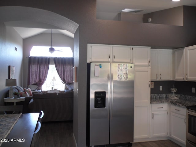 1333 N Higley Rd Unit 7, Mesa, AZ 85205 - kitchen with stainless steel appliances, lofted ceiling, dark wood finished floors, arched walkways, and white cabinets