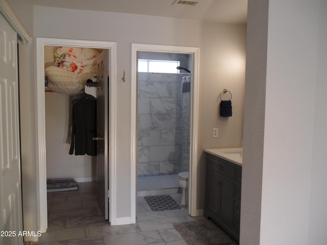 1333 N Higley Rd Unit 7, Mesa, AZ 85205 - full bathroom featuring marble look tiles, a shower stall, vanity, toilet, and a closet