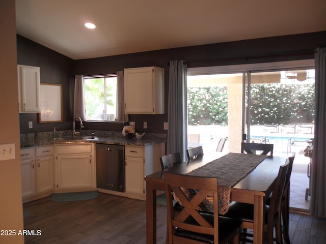 1333 N Higley Rd Unit 7, Mesa, AZ 85205 - kitchen featuring stainless steel dishwasher, a sink, wood finished floors, white cabinetry, and lofted ceiling