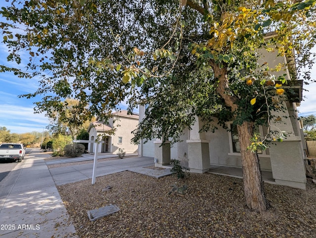 obstructed view of property with a garage