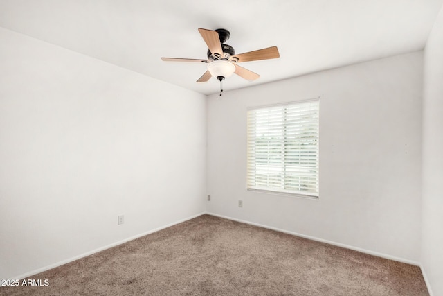 empty room with carpet floors and a ceiling fan