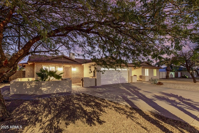 ranch-style house with a fenced front yard, a gate, driveway, and a garage