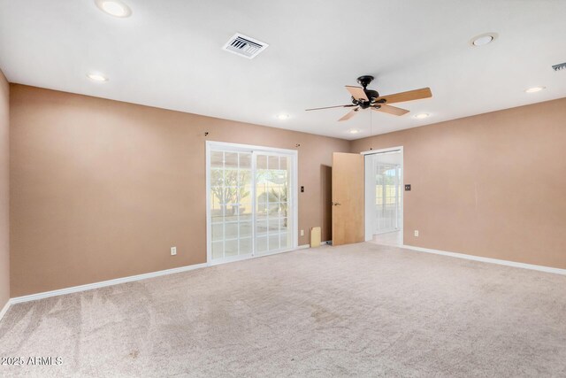 empty room with recessed lighting, visible vents, light carpet, and baseboards