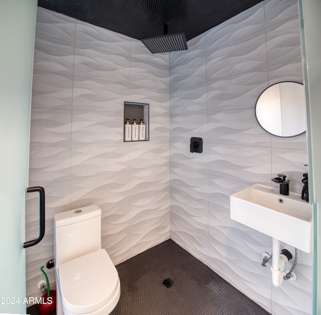 bathroom with toilet, tile walls, and a shower with shower door