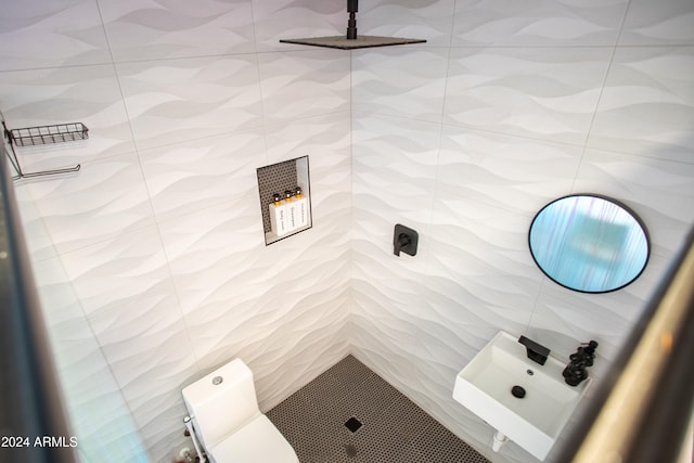 bathroom with a shower and tile walls