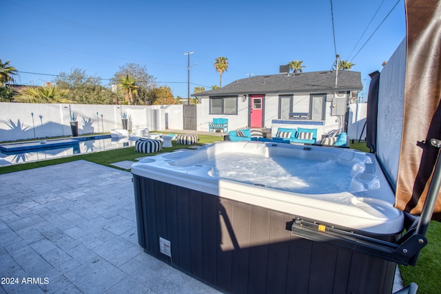 view of patio / terrace featuring a pool with hot tub