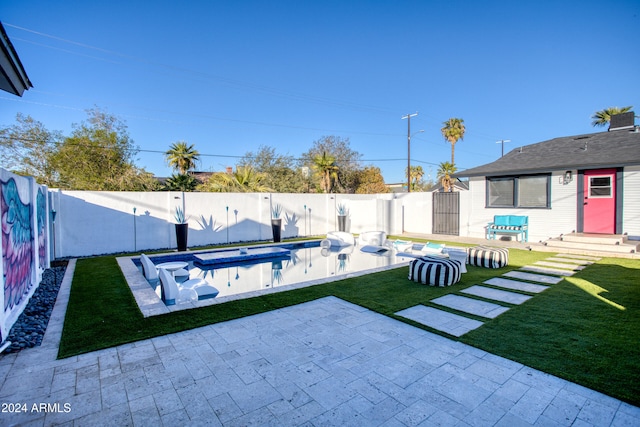 view of yard featuring a fenced in pool and a patio