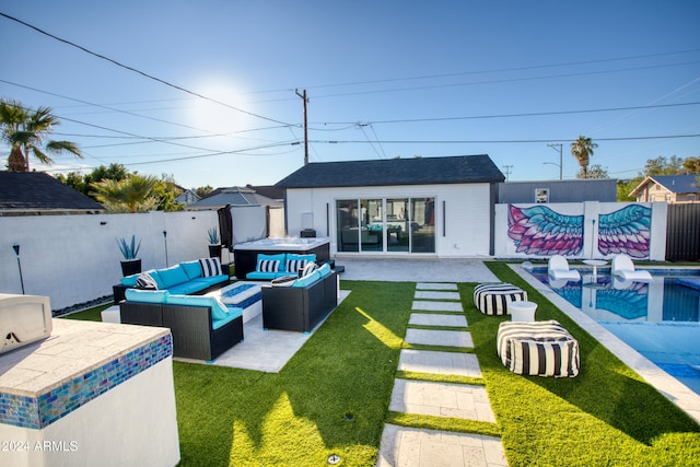 back of property featuring outdoor lounge area, a yard, an outdoor structure, a patio area, and a swimming pool with hot tub