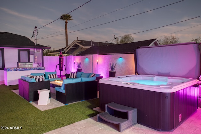 patio terrace at dusk featuring outdoor lounge area and a hot tub