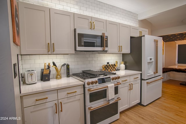 kitchen with stainless steel appliances, light stone counters, beamed ceiling, backsplash, and light wood-type flooring