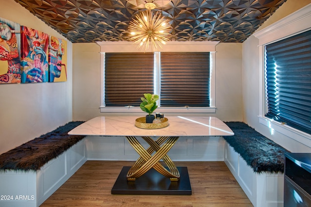 dining area featuring hardwood / wood-style floors and lofted ceiling