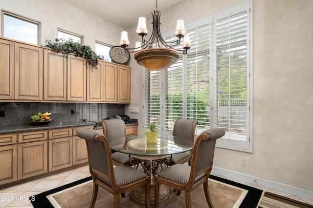 dining area featuring light tile patterned floors and a chandelier