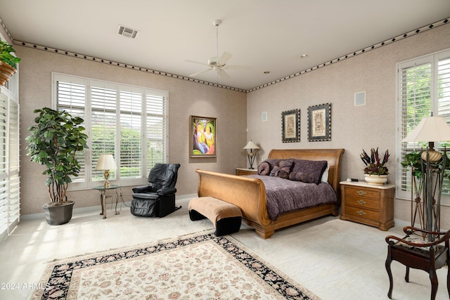 bedroom featuring multiple windows and ceiling fan