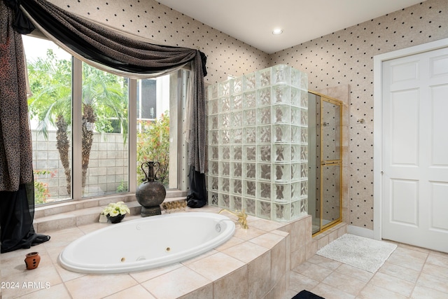 bathroom with tile patterned floors and independent shower and bath