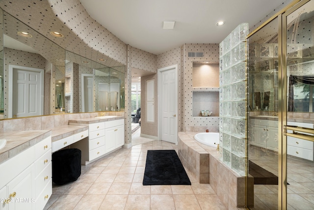 bathroom featuring tile patterned floors, plus walk in shower, and vanity