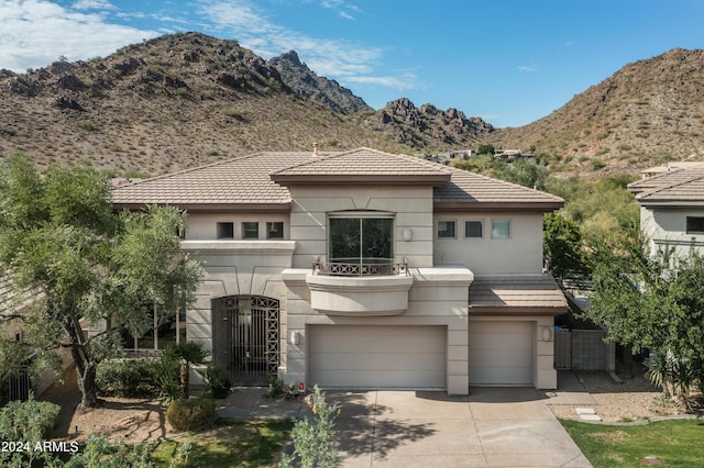 view of front of property with a mountain view and a garage