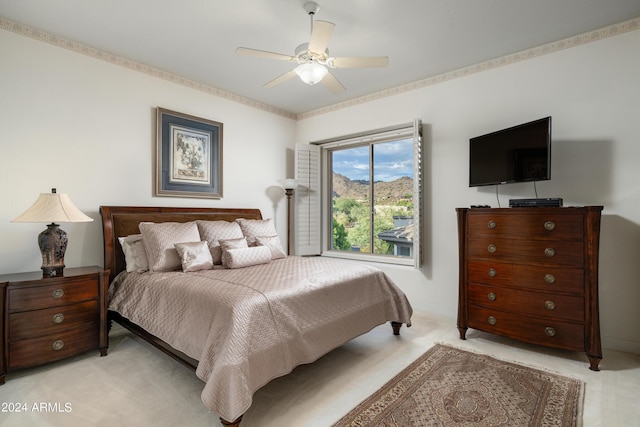 bedroom featuring light colored carpet and ceiling fan