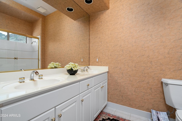 bathroom featuring tile patterned flooring, vanity, an enclosed shower, and toilet