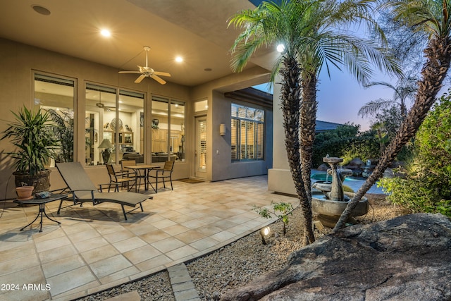 patio terrace at dusk with ceiling fan